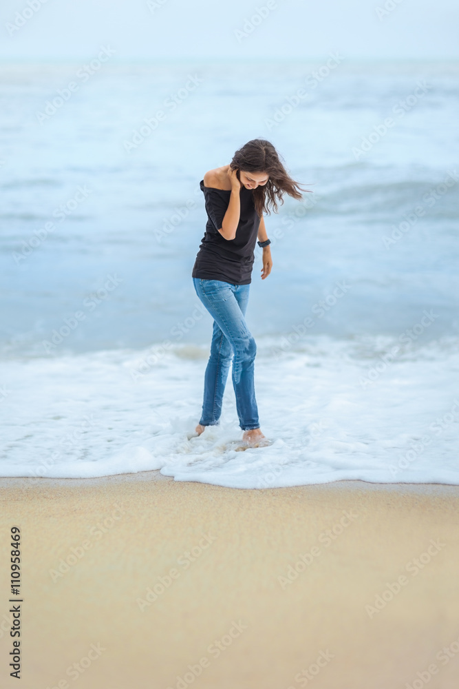 lonely beautiful woman walking on tropical beach