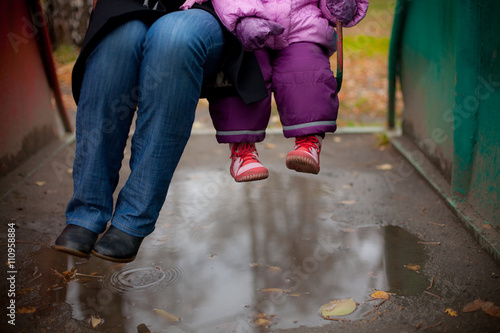 adult and child swinging on a swing