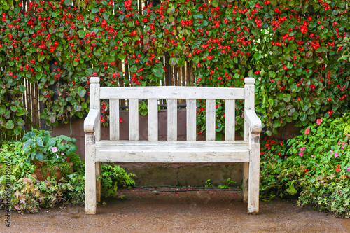 White bench with flower background, selective focus