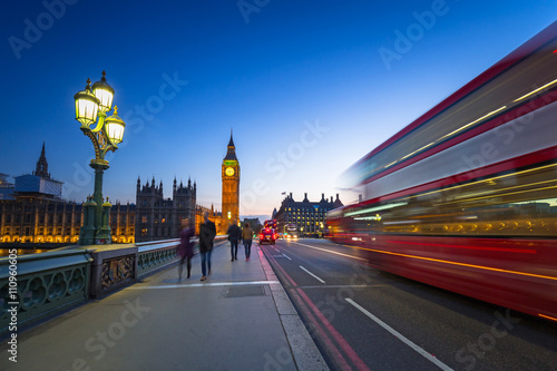 London scenery at Westminter bridge with Big Ben and blurred red bus, UK