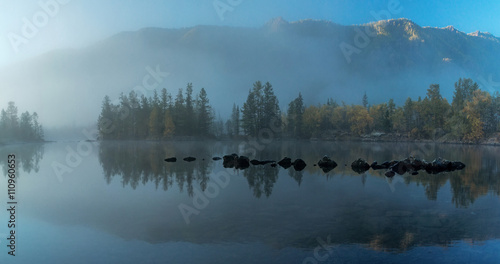 Morning mist on the river Zhombolok photo