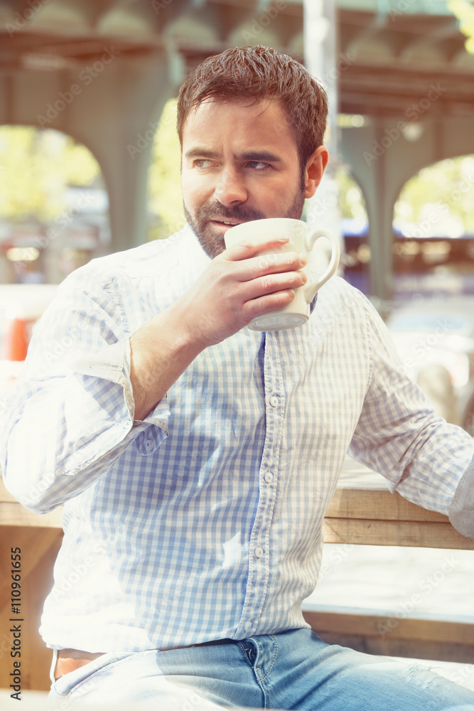 handsome man sitting outside and drinking coffee handsome man sitting outside and drinking coffee
