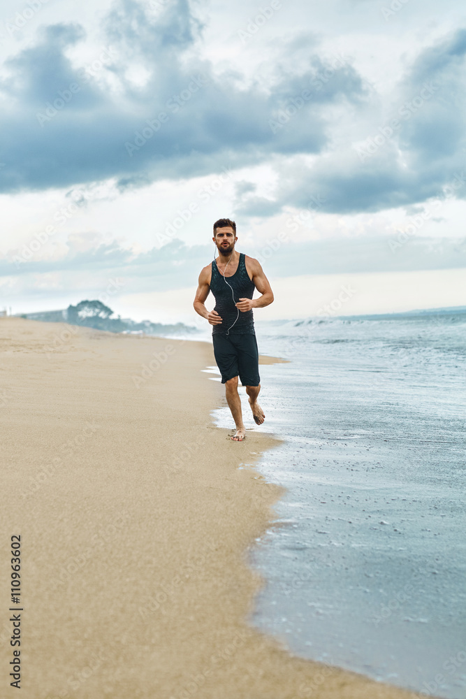 Sports. Handsome Fit Athletic Man Running On Beach. Sporty Runner Jogging Near Sea During Outdoor Workout. Healthy Active Jogger Exercising And Training For Marathon. Fitness Concept Sports. Handsome Fit Athletic Man Running On Beach. Sporty Runner Jogging Near Sea During Outdoor Workout. Healthy Active Jogger Exercising And Training For Marathon. Fitness Concept