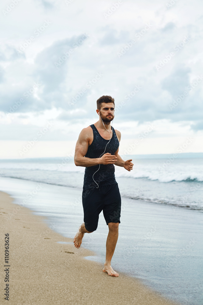 Running Man. Sporty Runner Enjoying Run By Sea During Outdoor Workout. Handsome Fit Athletic Male Jogging On Beach. Healthy Active Jogger Exercising And Training For Marathon. Fitness, Sports Concept Running Man. Sporty Runner Enjoying Run By Sea During Outdoor Workout. Handsome Fit Athletic Male Jogging On Beach. Healthy Active Jogger Exercising And Training For Marathon. Fitness, Sports Concept
