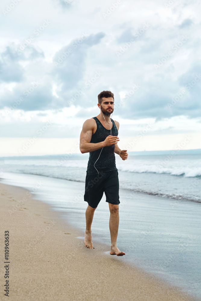Running Man. Sporty Runner Enjoying Run By Sea During Outdoor Workout. Handsome Fit Athletic Male Jogging On Beach. Healthy Active Jogger Exercising And Training For Marathon. Fitness, Sports Concept Running Man. Sporty Runner Enjoying Run By Sea During Outdoor Workout. Handsome Fit Athletic Male Jogging On Beach. Healthy Active Jogger Exercising And Training For Marathon. Fitness, Sports Concept