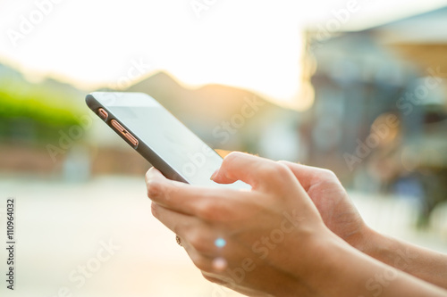 Woman using cellphone at outdoor