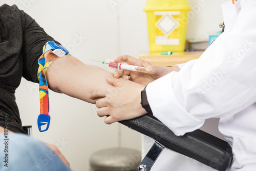Cropped Image Of Doctor Collecting Blood From Patient