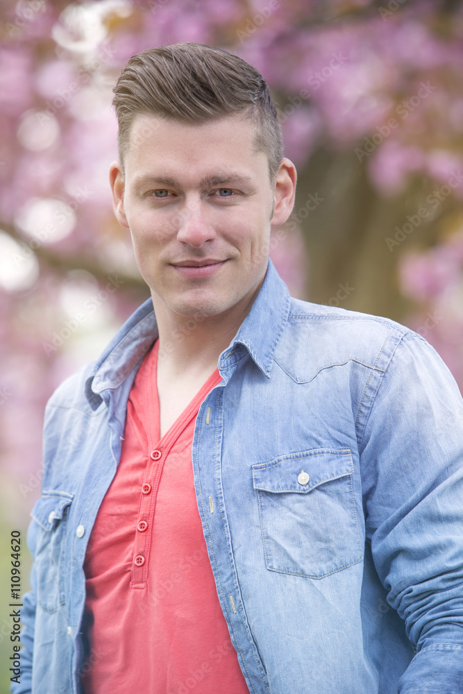 portrait of man outdoors with cherry blossom portrait of man outdoors with cherry blossom
