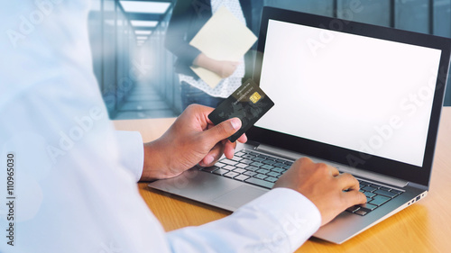 Foto Online shopping with black credit card and laptop computer