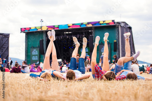 Legs of teenagers, music festival, in front of stage photo