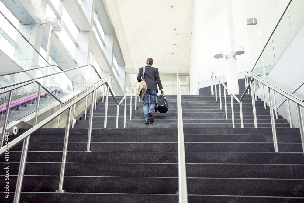 Businessman on business trip going up stairs, New York, USA Businessman on business trip going up stairs, New York, USA