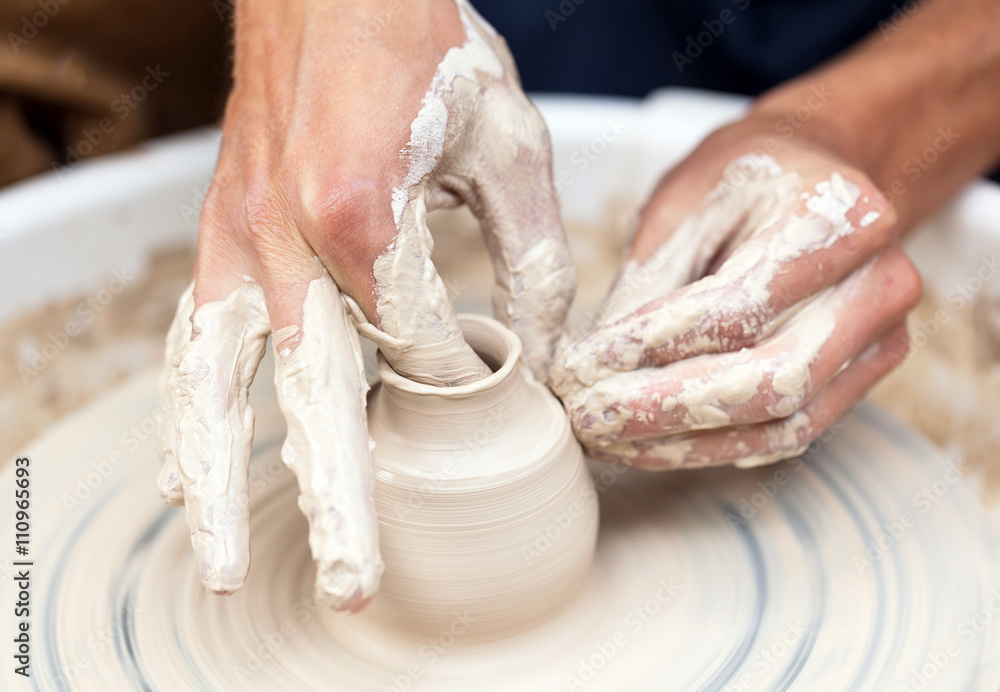 Master potter in his workshop produces pottery