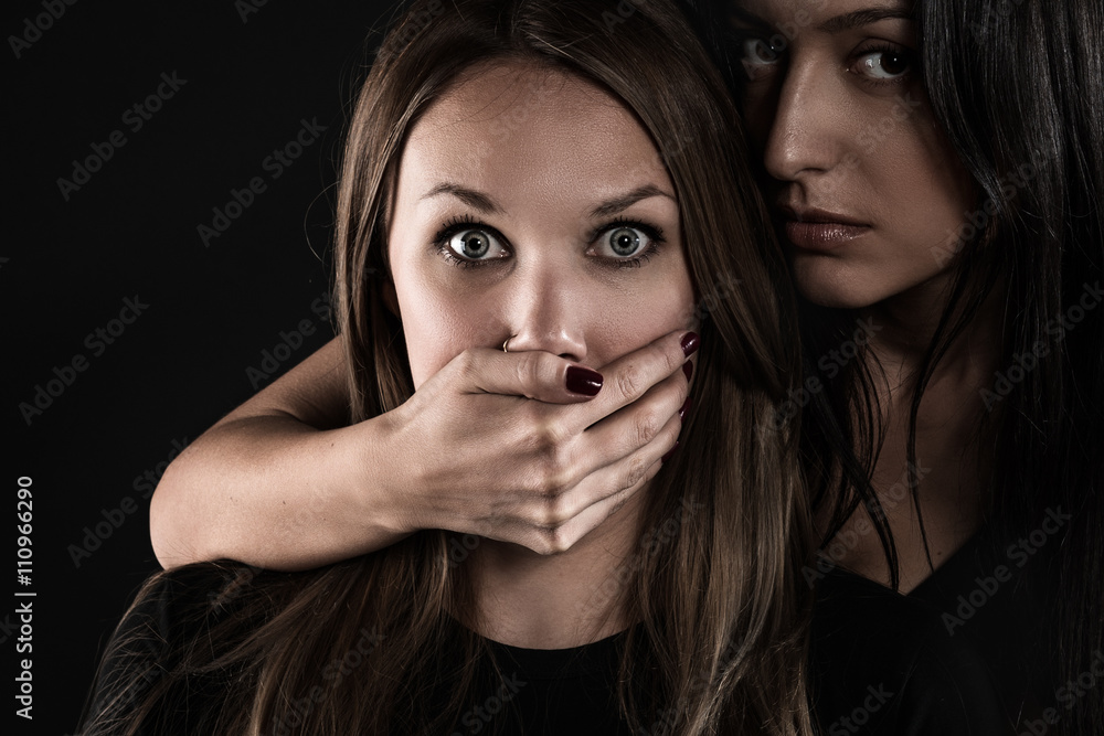 Premium Photo  Young woman closing mouth of her partner with hand