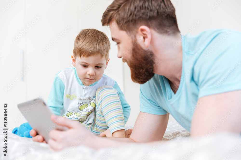Father and son playing with tablet Father and son playing with tablet