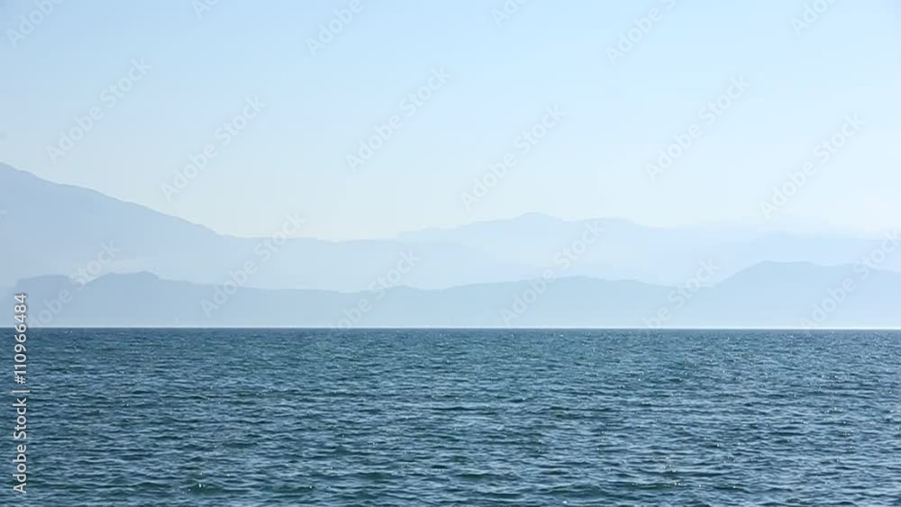 The landscape of Lake Garda with the Dolomite mountains in the background The landscape of Lake Garda with the Dolomite mountains in the background