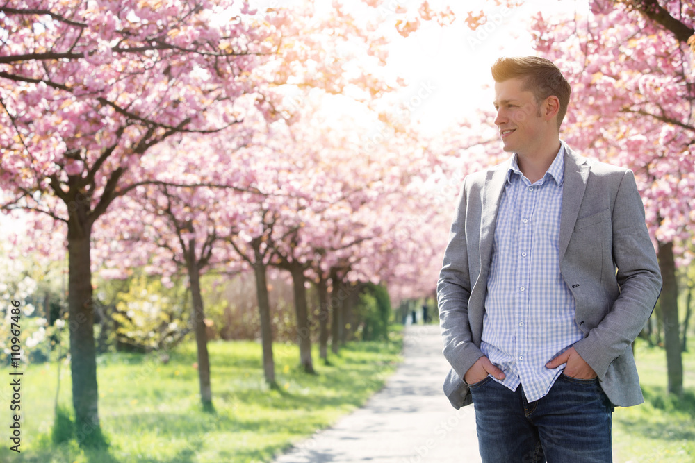 portrait of blond handsome man in the park portrait of blond handsome man in the park