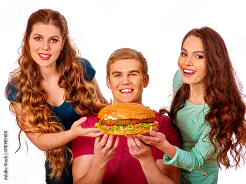 Group people holding hamburgers . Fast food concept. Happy handsome man on foreground. Women feeding man fast food. Isolated.