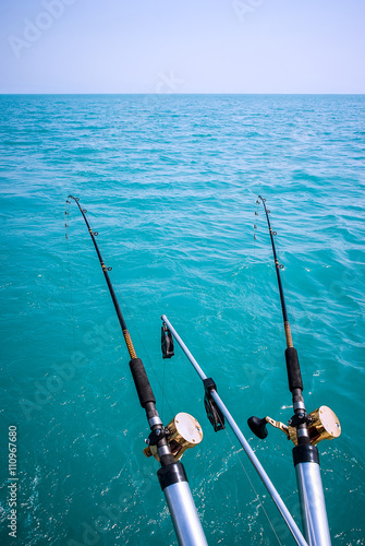 Two Fishing Poles Over Water