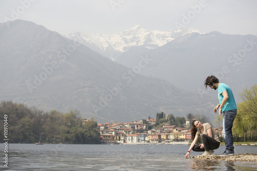 Young couple on lakeside, Lake Mergozzo, Verbania, Piemonte, Italy photo