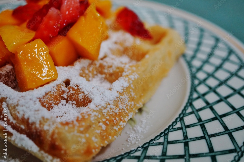 Freshly baked Belgian waffle with powdered sugar Freshly baked Belgian waffle with powdered sugar