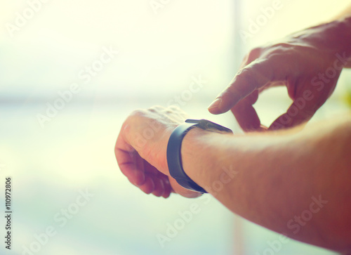 Person using smart watch. Young man making gestures on a smartwatch