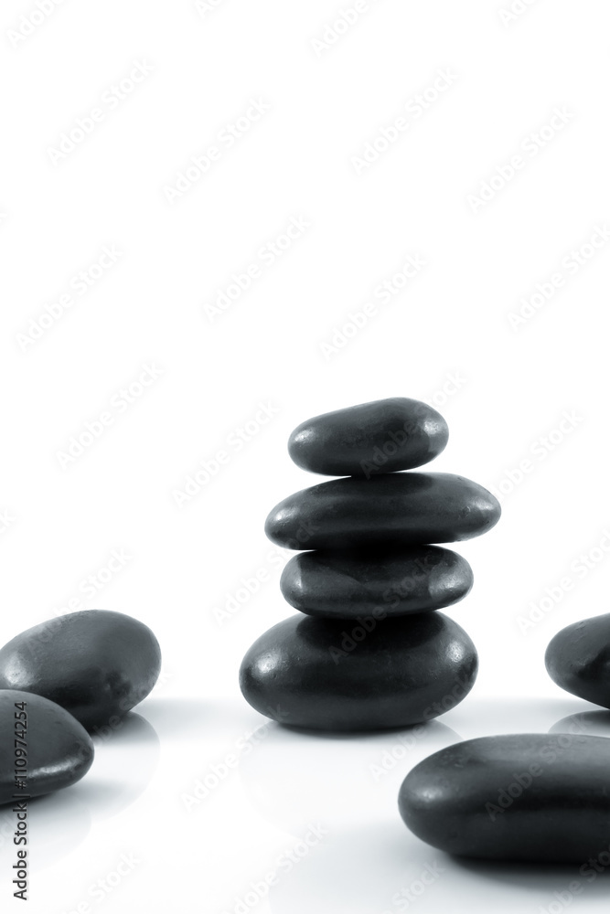Stack of black pebbles on white background Stack of black pebbles on white background