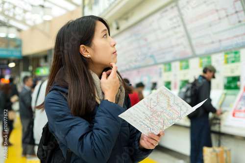 Photography Confused woman look for direction in train station