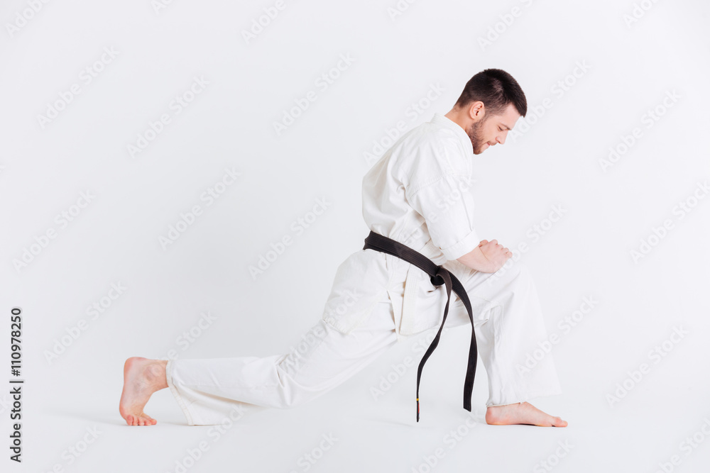 Fototapeta premium Young man in kimono warming up