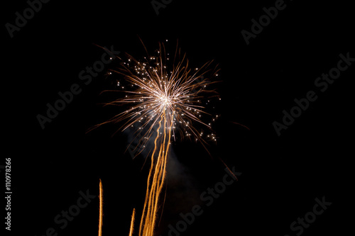 orange streaks shoot into the sky to explode