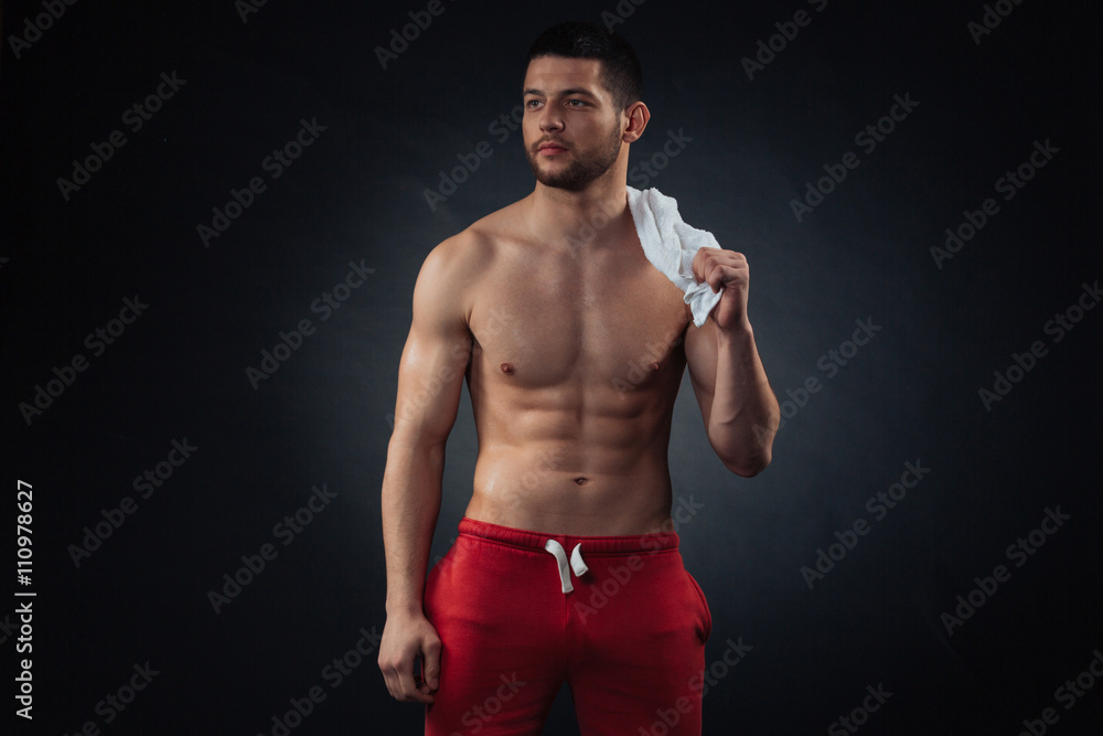 Fitness man with towel looking away
