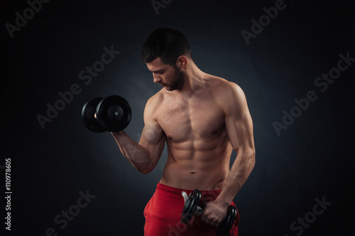 Handsome man workout with dumbbells