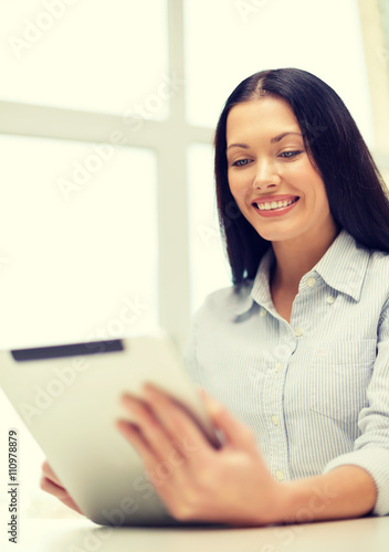 smiling businesswoman or student with tablet pc