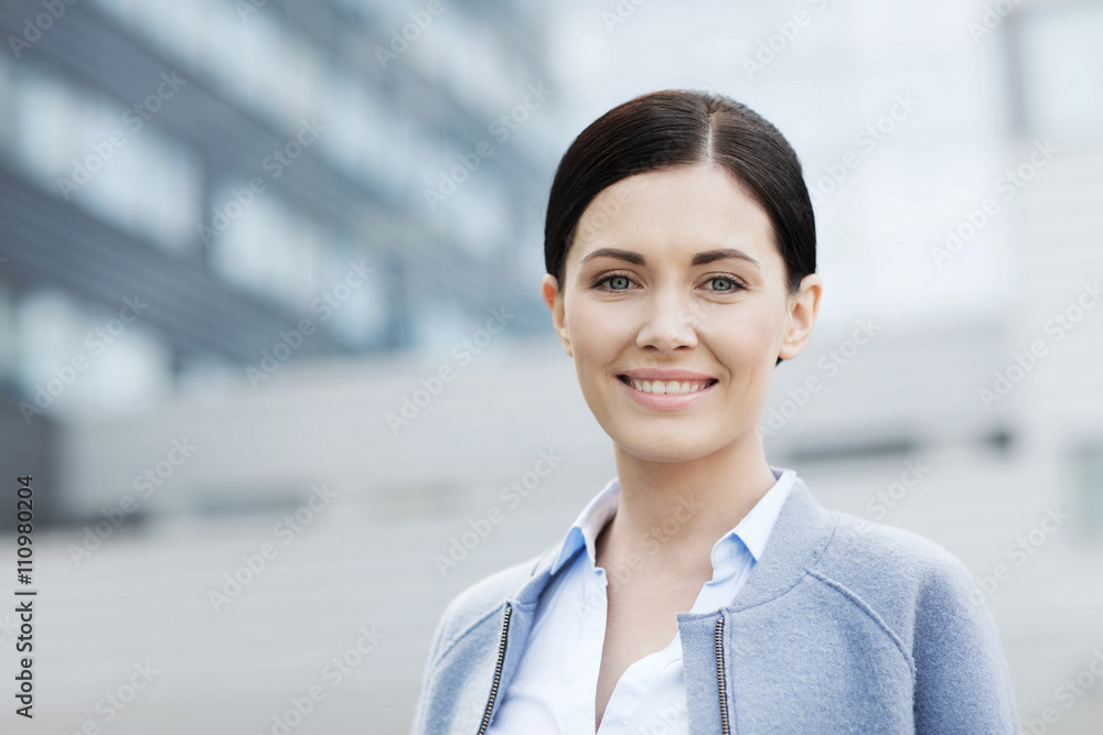 young smiling businesswoman over office building young smiling businesswoman over office building