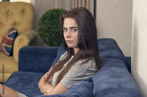 Thoughtful Teen Girl relaxing on the couch.