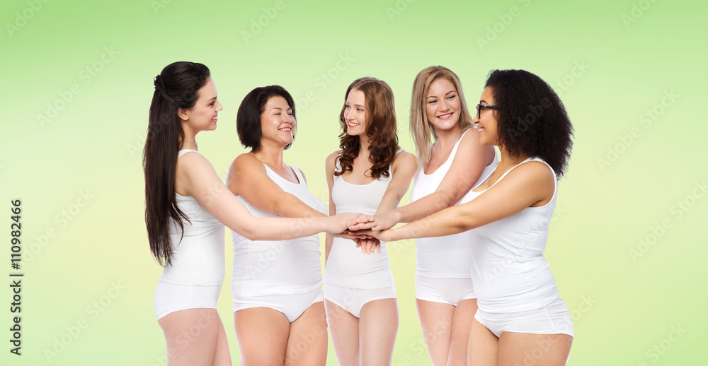 group of happy different women with hands on top