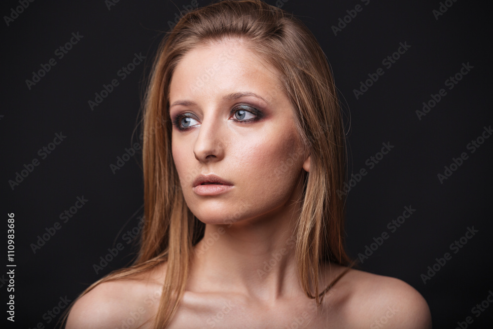 Charming woman looking away on black background Charming woman looking away on black background