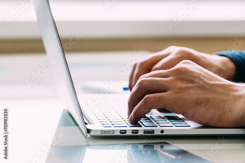 Businessmen's hands typing on laptop