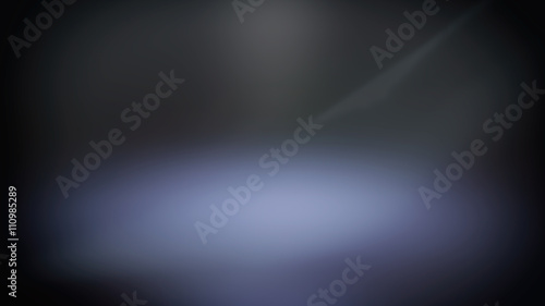 Blue blurred spotlight, dark abstract background