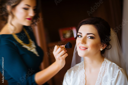 Beautiful bride wedding with makeup and hairstyle. Stylist makes make-up bride on wedding day. portrait of young woman at morning.