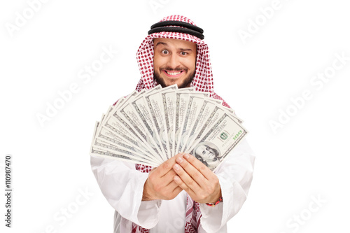 Joyful Arab holding a stack of money photo