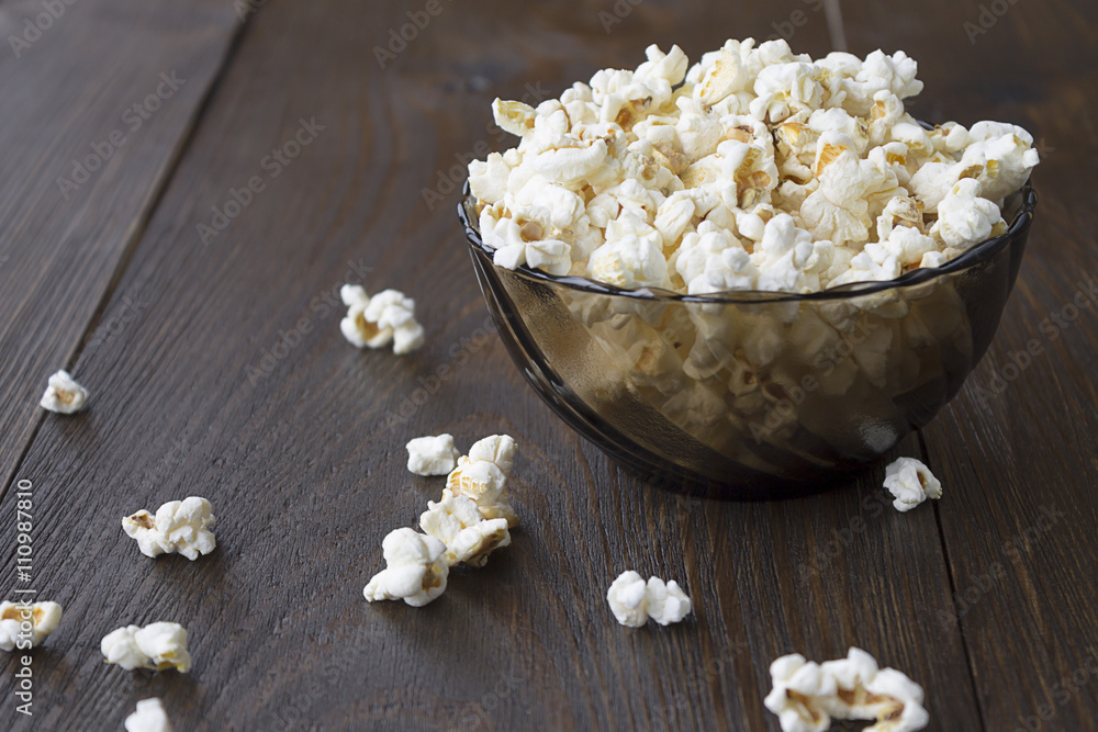 Salty popcorn on the wooden table Salty popcorn on the wooden table