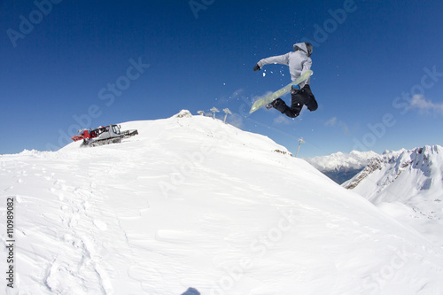 Snowboard rider jumping on mountains. Extreme snowboard freeride sport. © Vasily Merkushev