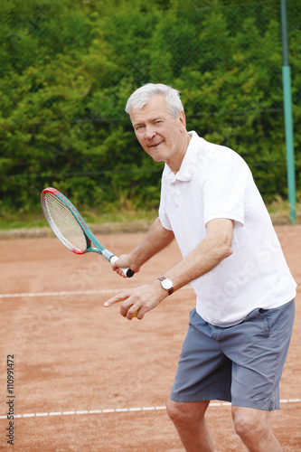 Elderly man playing tennis © sepy