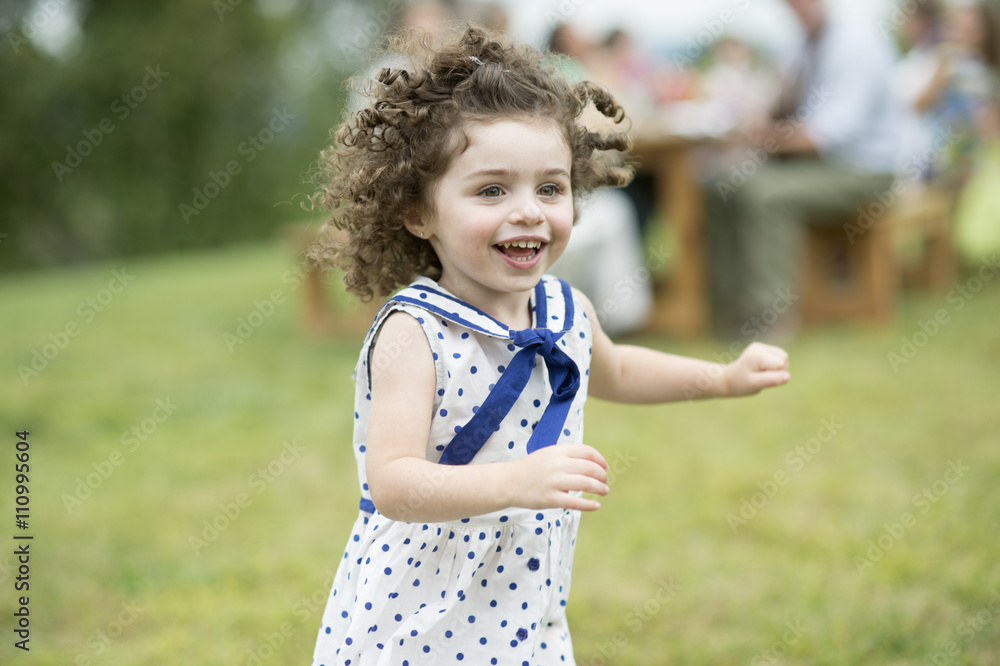 Young girl running and playing at family gathering Young girl running and playing at family gathering