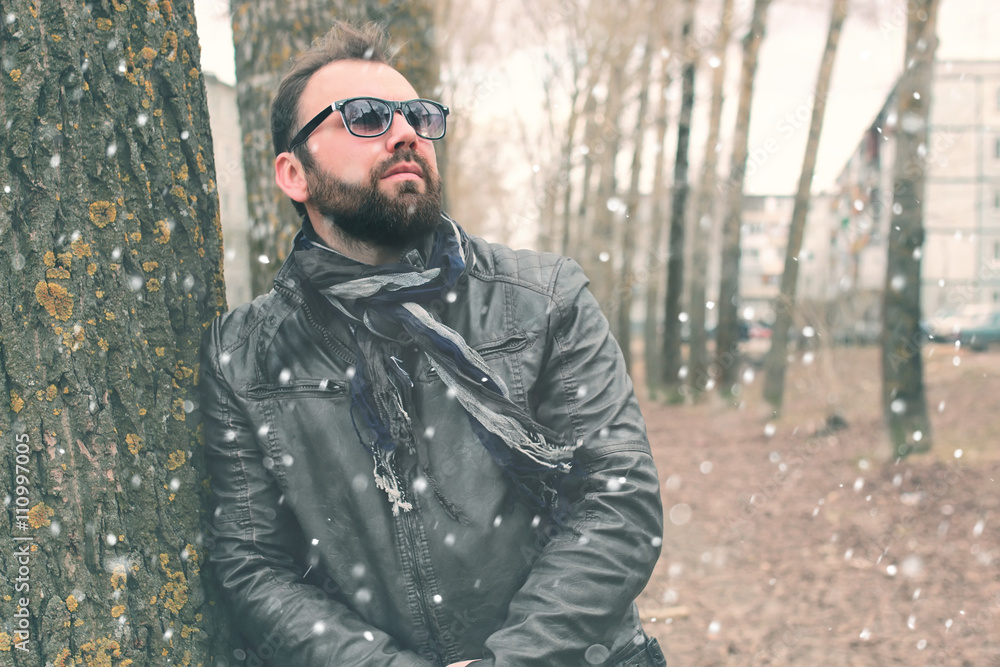 winter beard man in park with headphone