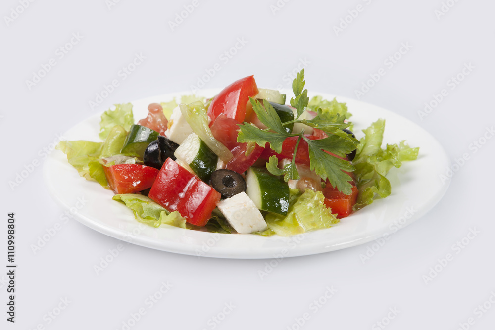 Greek Salad on white plate and gray background