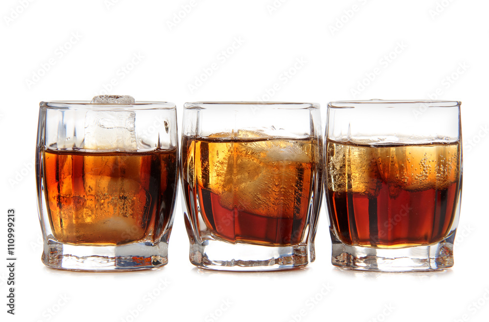 Glass jars with whiskey and ice on white background Glass jars with whiskey and ice on white background