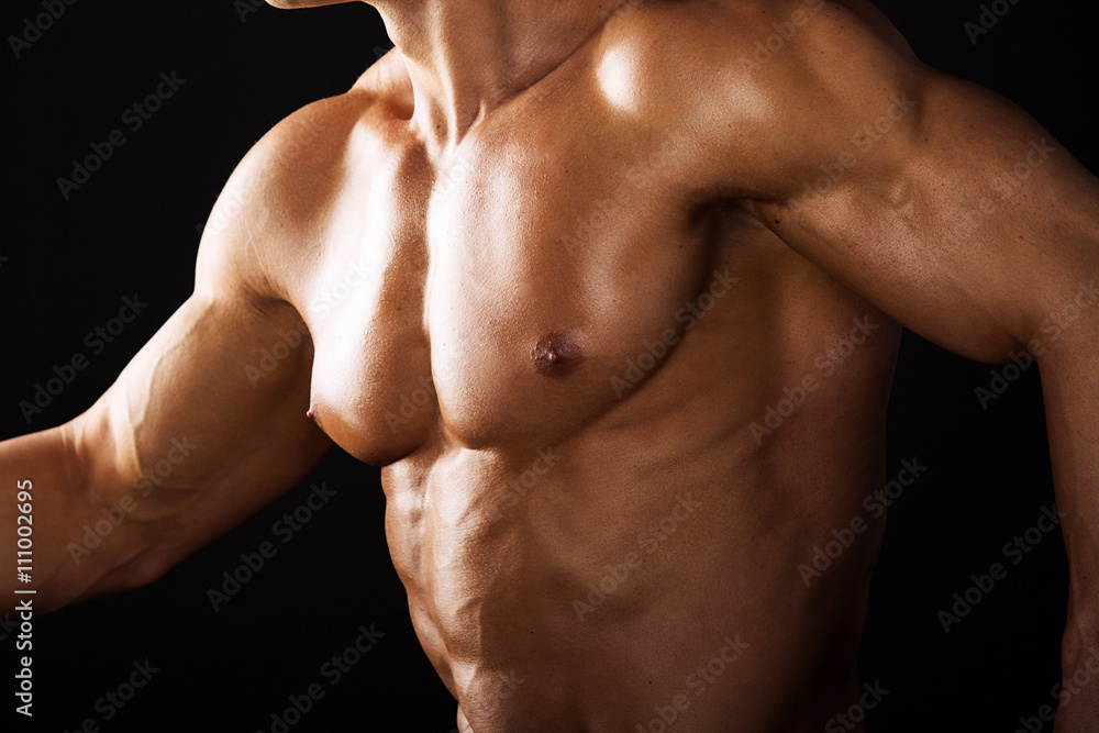 Strong Athletic Man showing muscular body black background.Muscular bodybuilder runing black background.Muscular man on black background