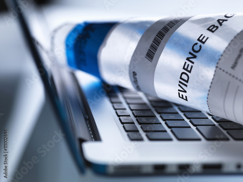 Close up of laptop computer ready to take away in forensic evidence bag