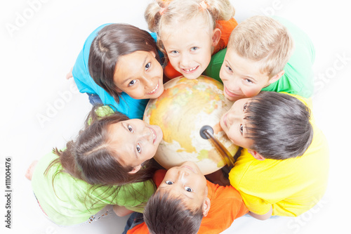 Group of international kids holding globe earth